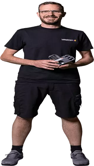 Loeschpack employee A Loeschpack employee holds a component in his hand