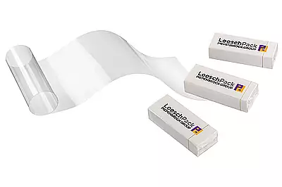 Cellophane wrapping machine LCM for bar packaging Three wrapped chocolate bars with foil wrapping
