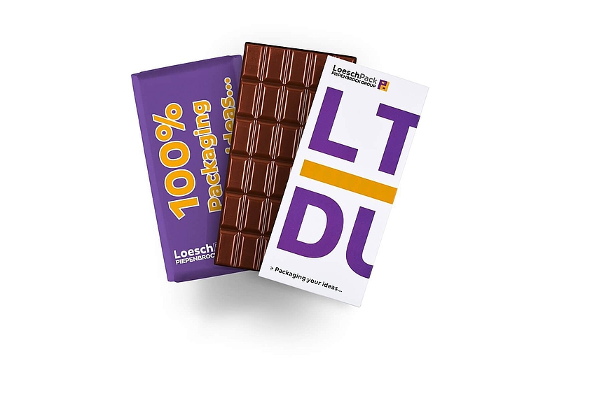 Chocolate bar with purple wrapper and white label reading 100% Packaging Ideas by LoeschPack company