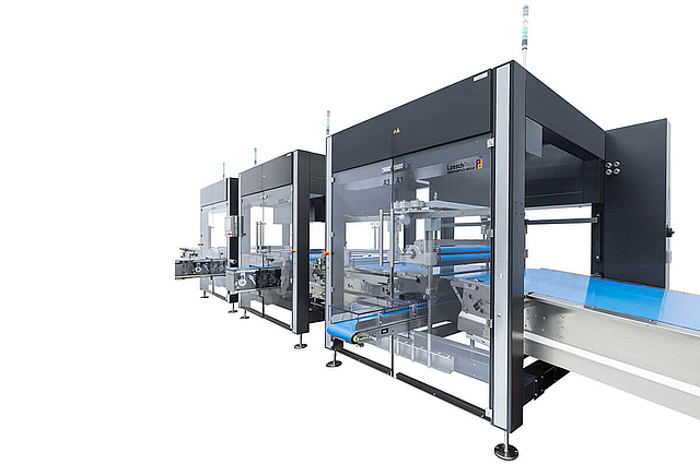 Sistema de alimentación y distribución Loeschpack LOMATIC para diversos productos Vista lateral del sistema Lomatic de alimentación y distribución de tabletas y tabletas de chocolate